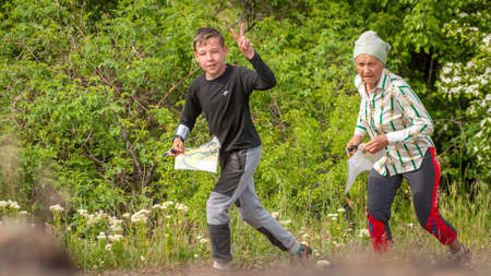 Village Aktovo, Ukraine - May 21, 2021: Orienteering race. Traditional annual game. Young athlete during orienteeringのeditorial素材