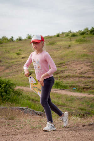 Village Aktovo, Ukraine - May 21, 2021: Orienteering race. Traditional annual game. Young athlete during orienteeringのeditorial素材