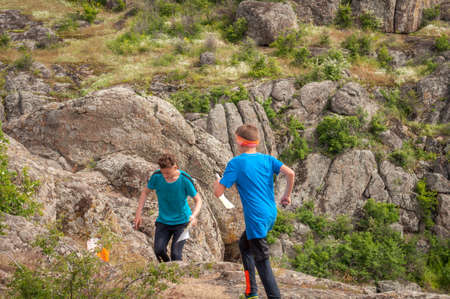 Village Aktovo, Ukraine - May 21, 2021: Orienteering race. Traditional annual game. Athlete during orienteering, checkpointのeditorial素材