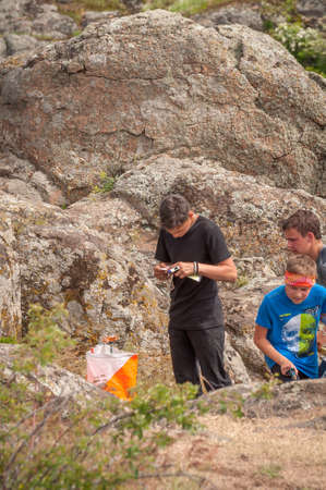Village Aktovo, Ukraine - May 21, 2021: Orienteering race. Traditional annual game. Athlete during orienteering, checkpointのeditorial素材