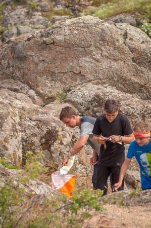 Village Aktovo, Ukraine - May 21, 2021: Orienteering race. Traditional annual game. Athlete during orienteering, checkpointのeditorial素材
