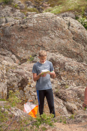 Village Aktovo, Ukraine - May 21, 2021: Orienteering race. Traditional annual game. Athlete during orienteering, checkpointのeditorial素材