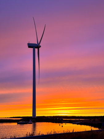Wind against the turbine backdrop of a beautiful sunset.