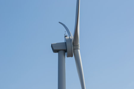 Close-up of wind turbine against blue sky. Concept of green, clean, renewable energy.の写真素材
