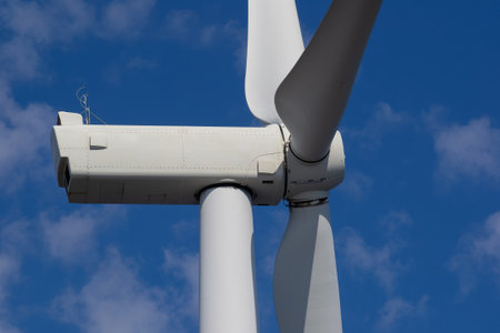 Close-up of wind turbine against blue sky. Concept of green, clean, renewable energy.の写真素材