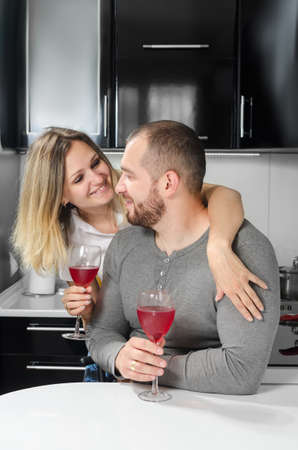 couple in love drinking wine at homeの写真素材