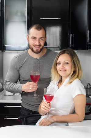 couple in love drinking wine at homeの写真素材
