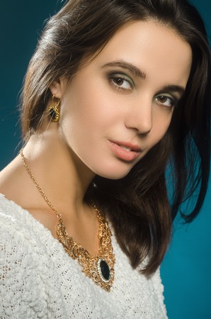 Studio portrait of beautiful woman on blue backgroundの写真素材