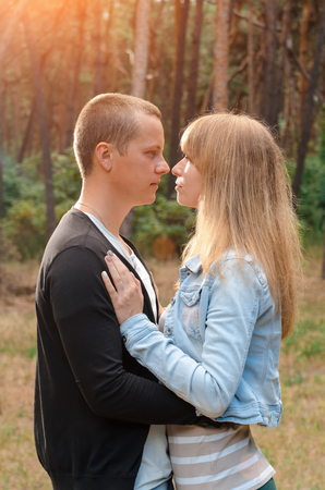 Couple loving each other outdoors in a pine forestの写真素材