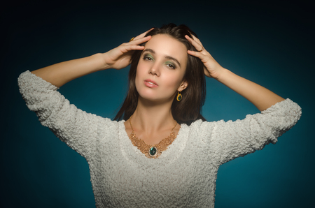 woman posing in studio on blue backgroundの写真素材