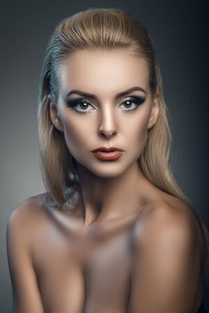 fashion studio portrait of young beautiful woman on dark backgroundの写真素材