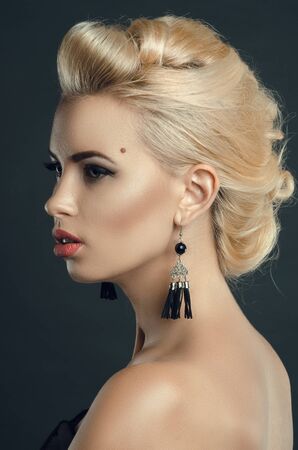 beautiful young woman in Studio on a dark background. Fashion portrait of a blondeの写真素材