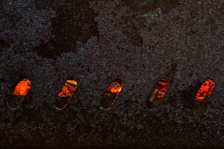 Red hot coals in an old rusty leaky grill on which shish kebabs are friedの写真素材
