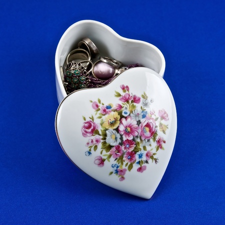 Small ceramic chest white color with bijouterie on a blue background.の写真素材