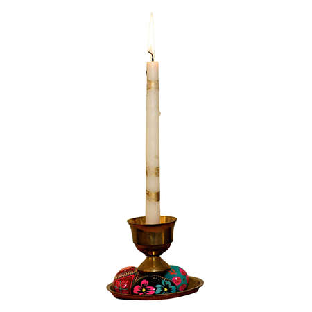 Painted handmade wooden easter eggs and candlestick isolated on white background の写真素材