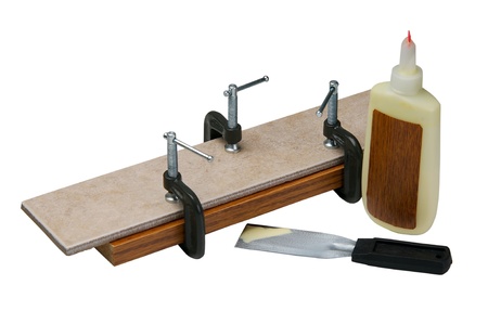 Adjusting clamps on wood and ceramic isolated on a white background.の写真素材