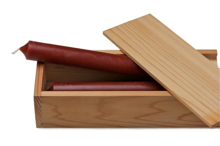 Wooden box with a brown candles isolated on a white background.の写真素材