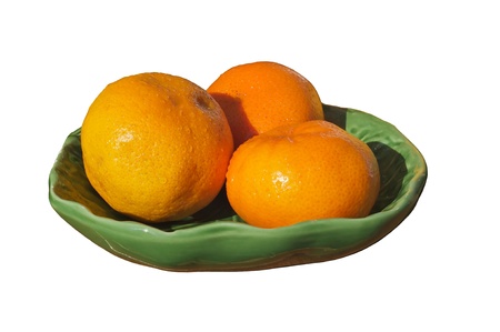 Fresh wet oranges on a plate isolated on a white background.の写真素材