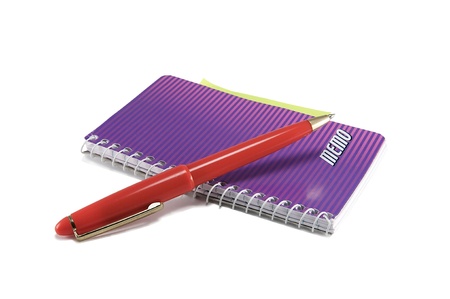 A red pen and notebook isolated on a white background.の写真素材