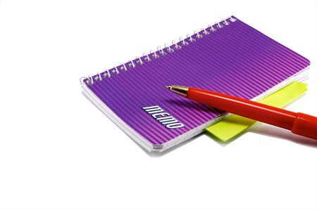 A red pen and notebook isolated on a white background.の写真素材