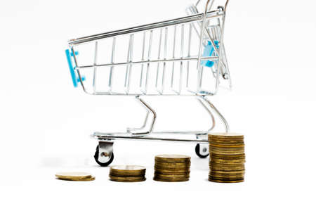 Money and shopping cart on a white background.Business concept. Empty shopping cart.の写真素材