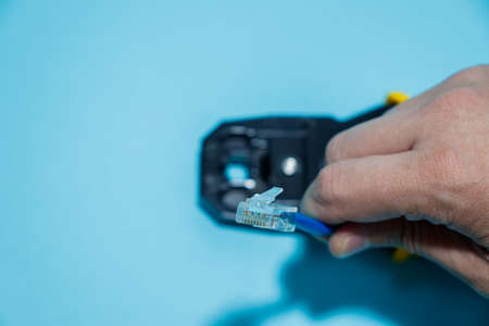 internet or telephone line cables and crimper, Twisting Cable Tool Twisted Pair internet UTP Cat 5, Crimping RJ45 LAN cable, Stepping to crimping RJ45 connectorの写真素材