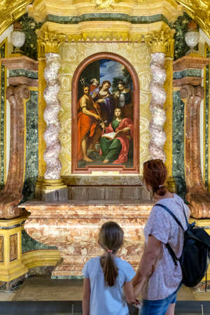 Mother and daughter observe an ancient canvas into Cappella San Brizio, Cathedral Orvieto, Umbria, Italyのeditorial素材