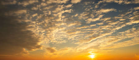 Colorful sunset sky with dramatic orange clouds. Only sky, no land.の写真素材