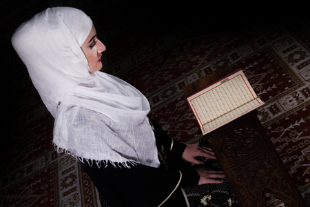 Muslim girl reading Koran in mosqueの写真素材