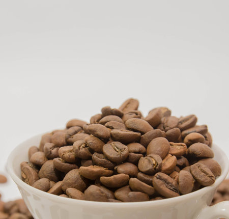 Cup with beans isolated on white backgroundの写真素材