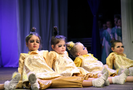 Little girls dancers are on stage, they opened their mouths and narrowed his eyes with big eyelashes. Children's choreography, performanceのeditorial素材