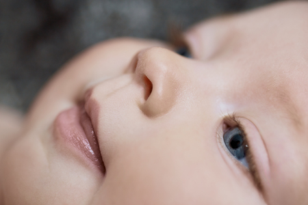 Close-up portrait of a beautiful cute adorable baby smilingの写真素材