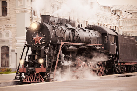 Retro steam train stands on the railway station の写真素材