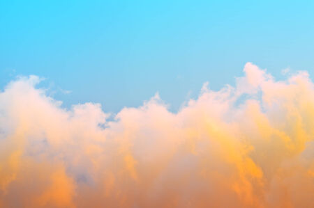 View of the sky above the clouds at sunset.
