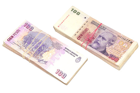 Two stacks of one hundred argentinean pesos banknotes isolated on white background.