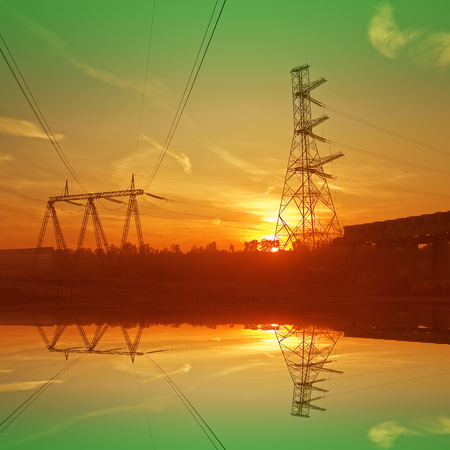 Construction of the bridge and electric cable line. Sunset image.