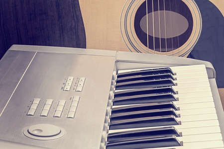 Digital midi keyboard and acoustic guitar in the studio.の写真素材