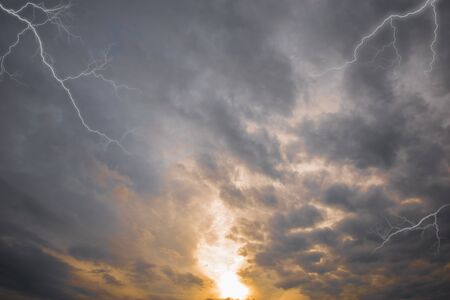 Evening sun and dark storm clouds before rain.の写真素材