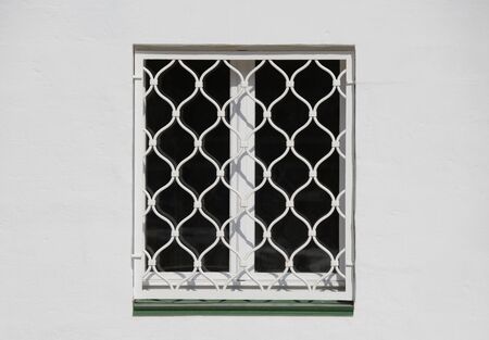 Closed window in the old building on sunny day.の写真素材