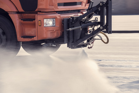 Cleaning machine washes the city street early in the morning.の写真素材
