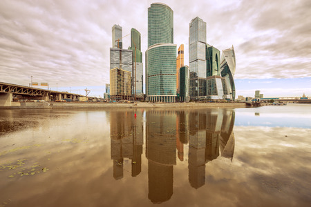 Early morning view of the business city center with its reflection in the river surface.の写真素材
