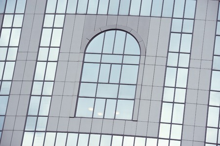Office building wall in the business city center at sunset time.の写真素材