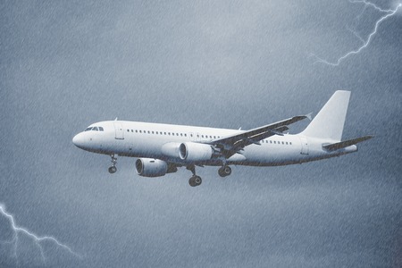 Landing of the passenger plane under the pouring rain.の写真素材