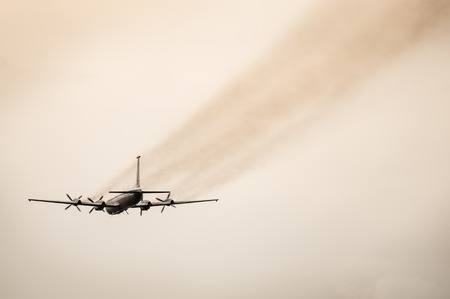 Flight of the retro passenger plane at sunset time.