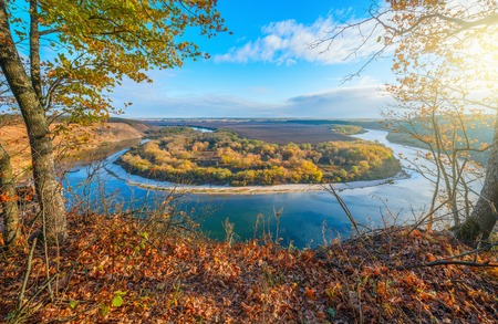 Autumn view of the river from the high hill at sunrise time.の写真素材