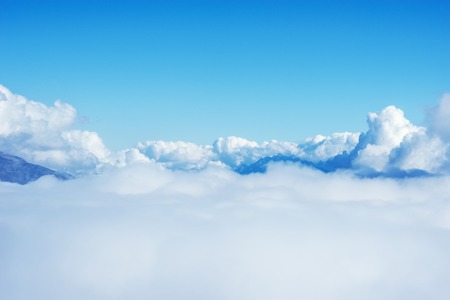 Clouds above the mountains at day time.の写真素材