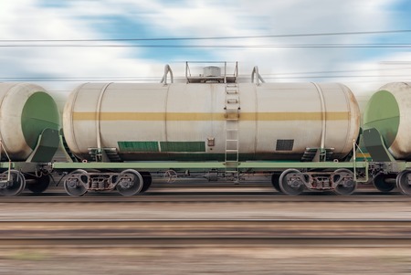 Tanker cars in the train moves fast through the station.の写真素材