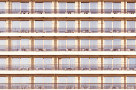 Windows and balconies of the hotel at sunset time.の写真素材