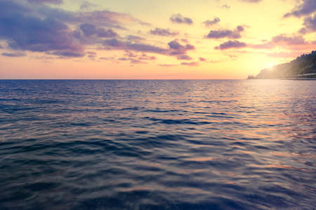 Calm surface of the sea at sunset time.の写真素材