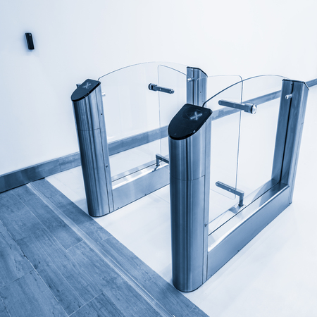Entrance to office with stainless steel turnstiles.の写真素材
